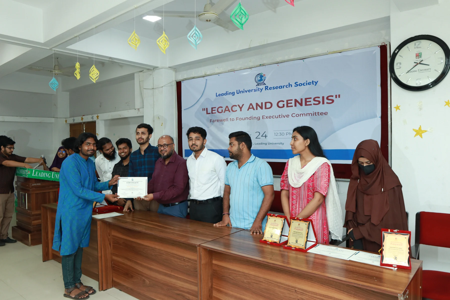 Receiving a certificate of appreciation for my contribution to organizing the Leading University Research Conference 2024.